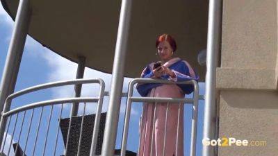 Watch this kinky redhead get a public surprise while peeing in the city - sexu.com
