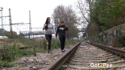 Brunette girls get desperate for a public pee session in the railway - sexu.com - Czech